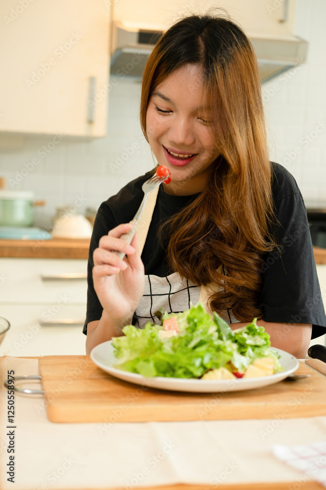 A female homecook enjoying her salad A female homecook enjoying her salad