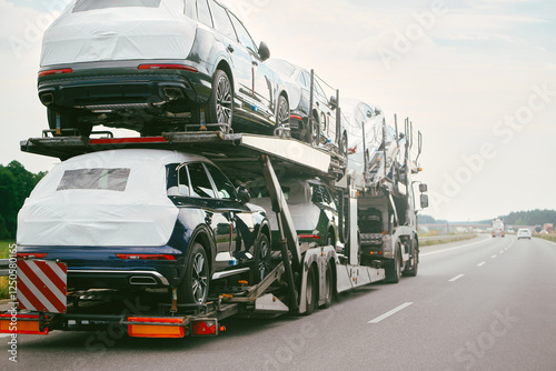 New SUVs being loaded on transport truck