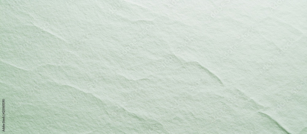 Obraz premium Pale green textured paper background for artistic and design applications showcasing subtle surface details and color variations.