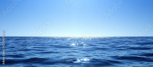 Wallpaper Mural Serene ocean surface with gentle ripples reflecting sunlight under a clear blue sky. Calm seascape ideal for relaxation and tranquility themes. Torontodigital.ca