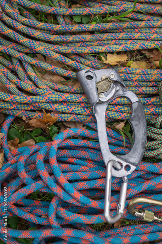 Rope in coils, carabiners, jumars and other equipment for sports tourism on the ground in the park, view from above photo