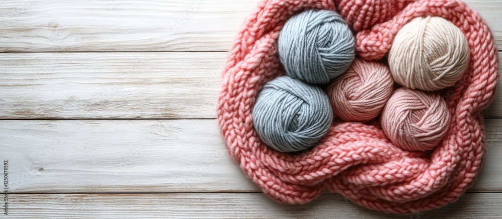 Knitting supplies with grey and pink wool yarn and needles on a white wooden background for crafting inspiration and cozy creative projects Knitting supplies with grey and pink wool yarn and needles on a white wooden background for crafting inspiration and cozy creative projects