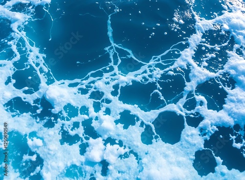 an image of a close up of a wave in the ocean, there is a wave coming in to the ocean with a blue sky photo