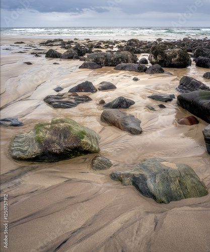 Beautiful patterns and lines and rocks on Stoer Beach, Lairg, Scotland photo