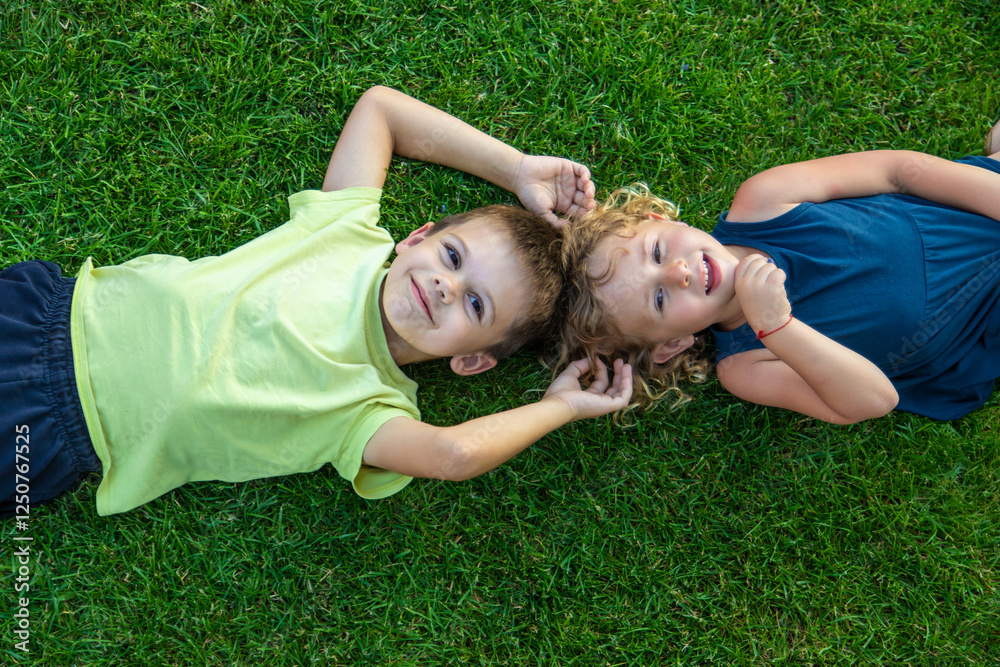 Child lying on green grass. Child looking at camera Child lying on green grass. Child looking at camera