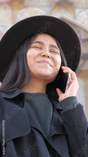 Elegant communication, woman speaking on her smartphone, merging style with modern technology.
