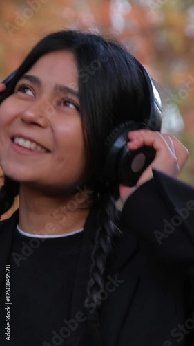 A playful young female dances to her favorite beats