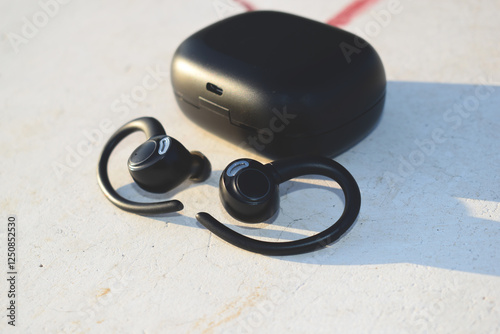 Black earbuds on white background