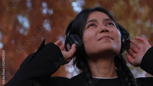Woman enjoying music in the park