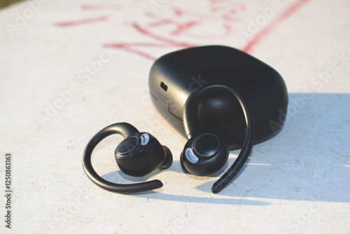 Black earbuds on white background