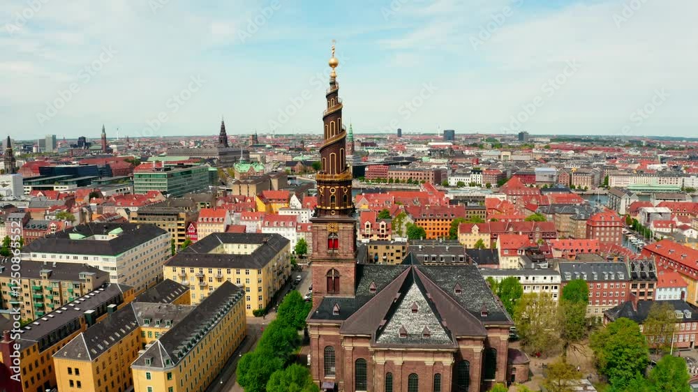 Push-in aerial shot of the golden spire of Church of Our Saviour, with a vast cityscape extending to the horizon. Push-in aerial shot of the golden spire of Church of Our Saviour, with a vast cityscape extending to the horizon.