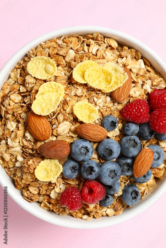 Fototapeta premium Delicious granola with berries on a color background