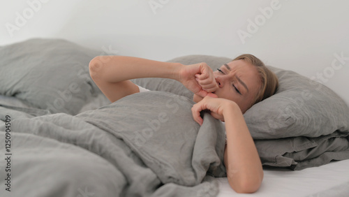 Sick Young Woman Coughing while Sleeping in Bed
