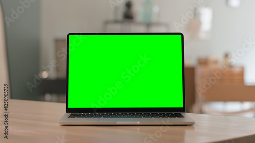 Laptop with Green Screen on Desk