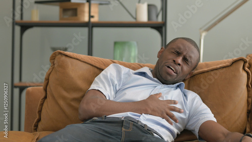 African Man with Chest Pain while Sitting in Bed