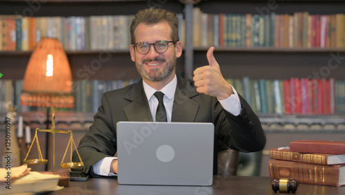 Middle Aged Lawyer with Thumbs Up Working on Laptop