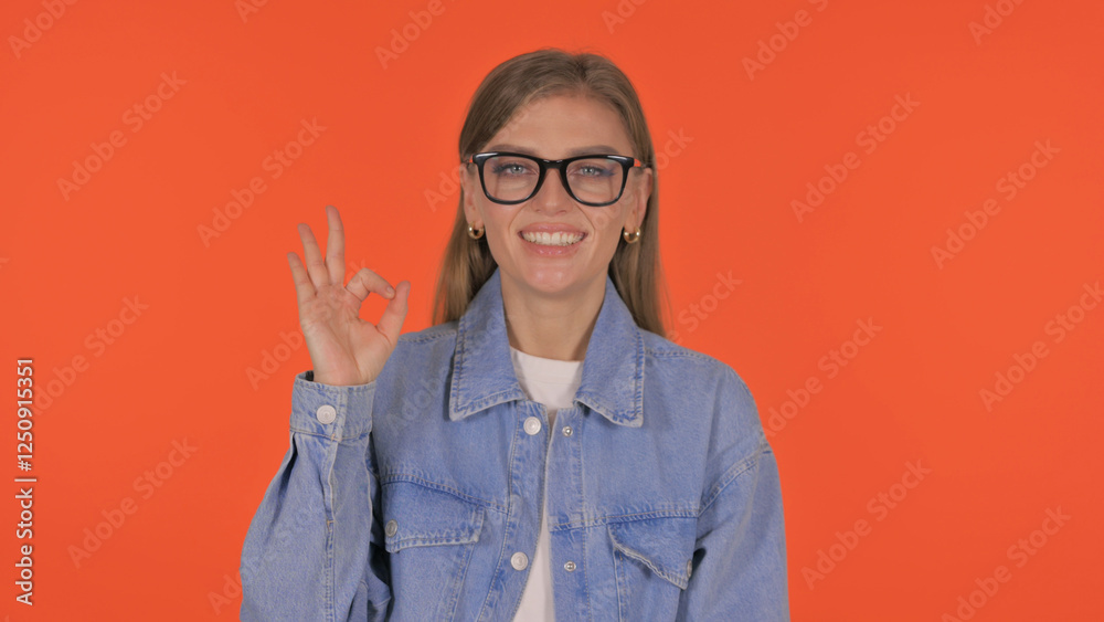 Casual Young Woman with Okay Sign on Orange Background, Portrait Casual Young Woman with Okay Sign on Orange Background, Portrait