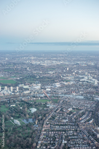 Obraz na płótnie Aerial view of London outskirts suburbs through early morning clouds with Thames river flowing at golden hour sunrise near industrial area w salonie