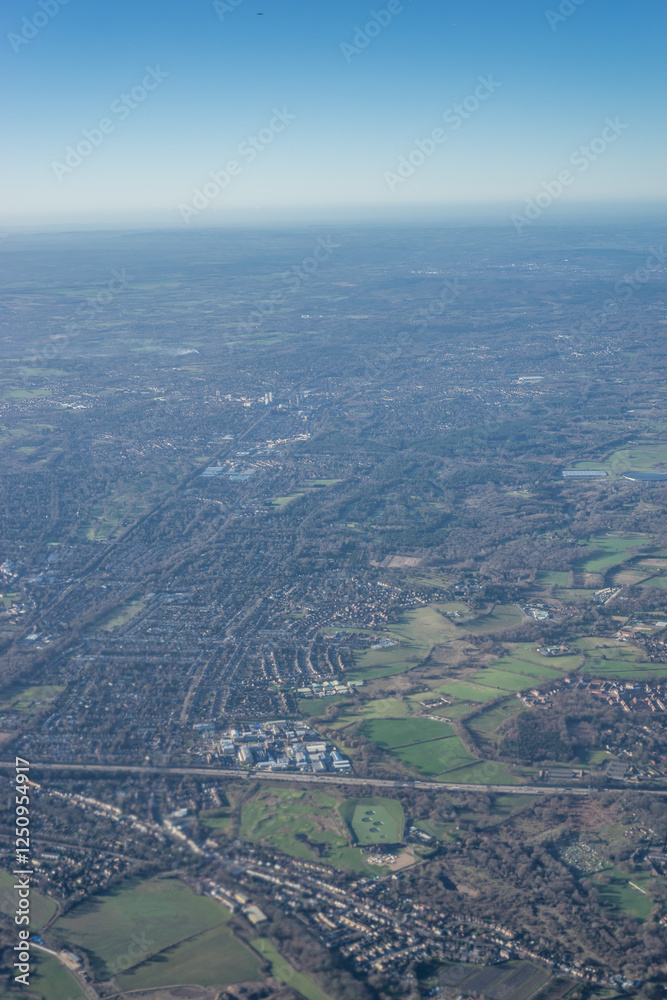 Aerial view of London outskirts suburbs from an aeroplane window