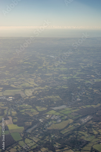 Obraz na płótnie Aerial view of London outskirts lush green fields from an aeroplane window w salonie