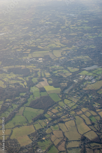 Obraz na płótnie Aerial view of London outskirts lush green fields from an aeroplane window w salonie