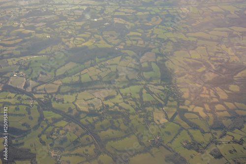 Obraz na płótnie Aerial view of London outskirts lush green fields from an aeroplane window w salonie