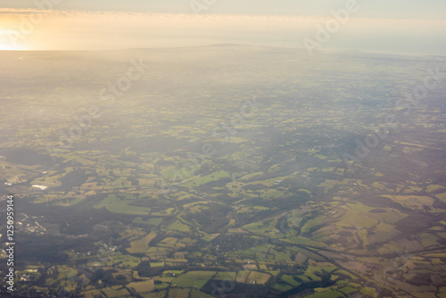 Obraz na płótnie Aerial view of London outskirts lush green fields from an aeroplane window w salonie