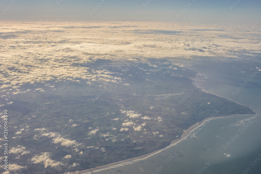 London, United Kingdom, England, a view of the ocean from an aeroplane window with clouds in the sky