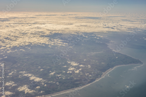 Obraz na płótnie London, United Kingdom, England, a view of the ocean from an aeroplane window with clouds in the sky w salonie