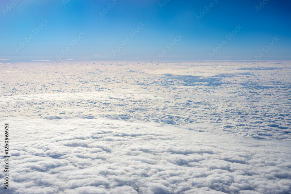 View of clouds from airplane window, clouds in a blue sky