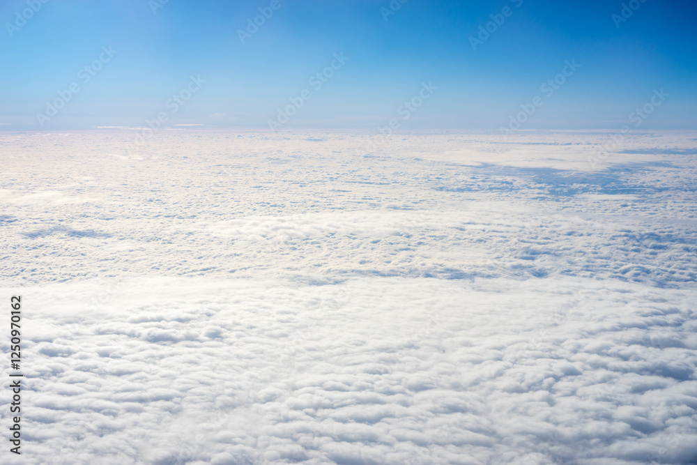 View of clouds from airplane window, clouds in a blue sky