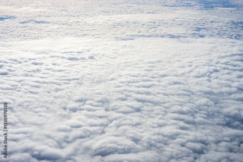 View of clouds from airplane window, clouds in a blue sky