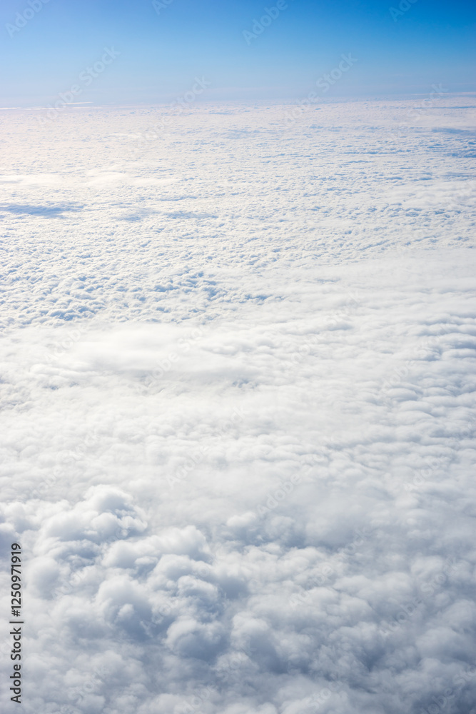 View of clouds from airplane window, clouds in a blue sky