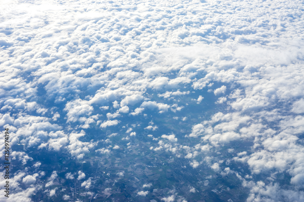 View of clouds from airplane window, clouds in a blue sky