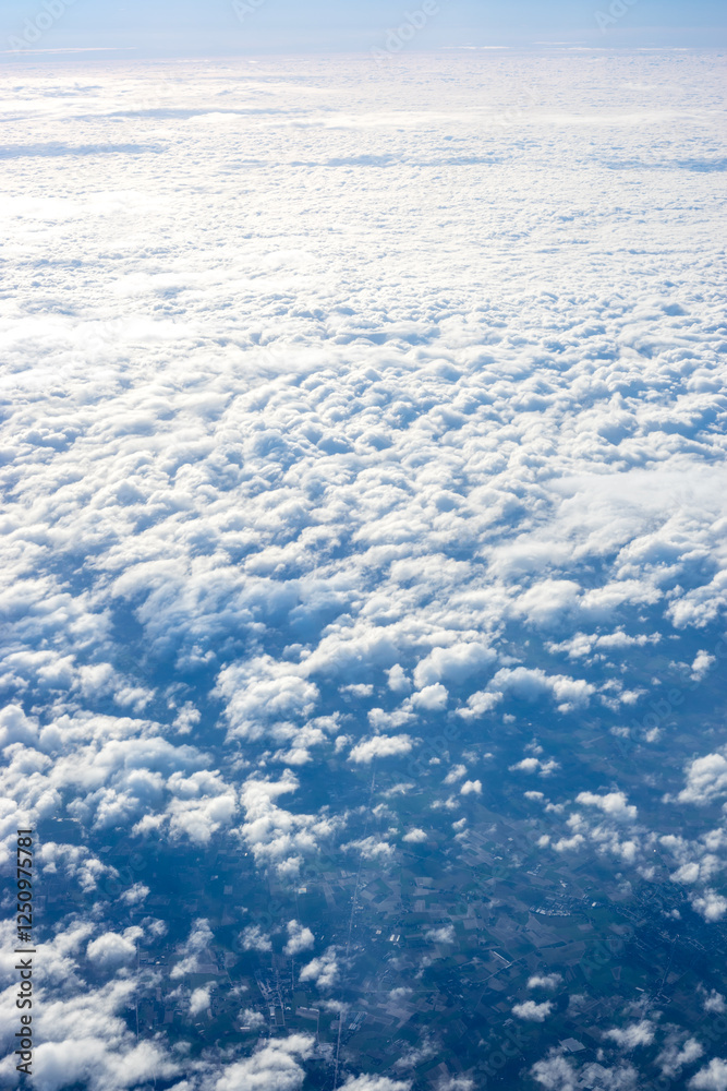 View of clouds from airplane window, clouds in a blue sky