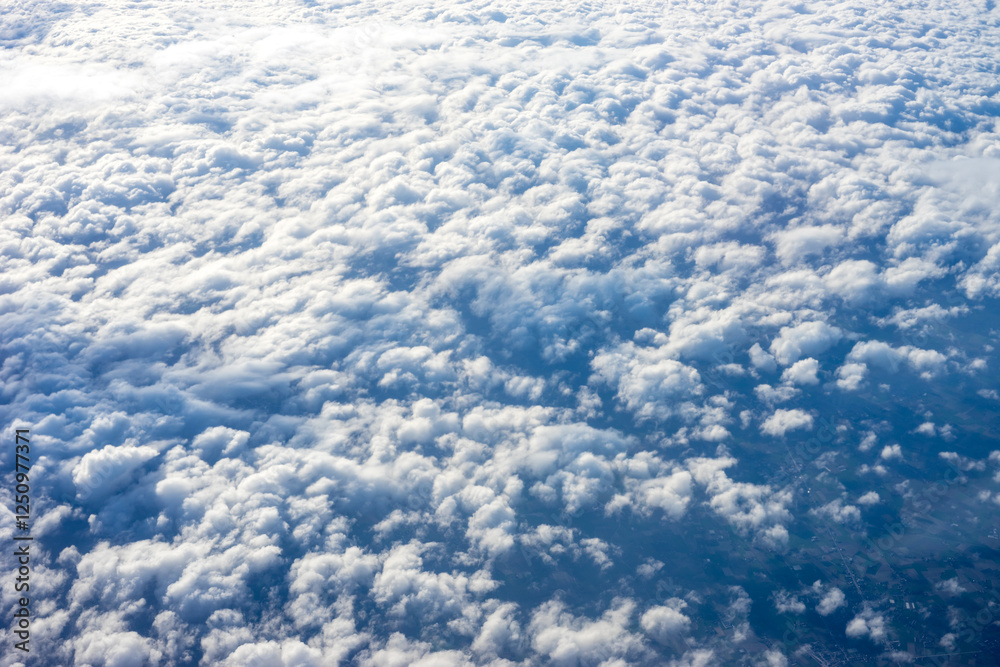 View of clouds from airplane window, clouds in a blue sky