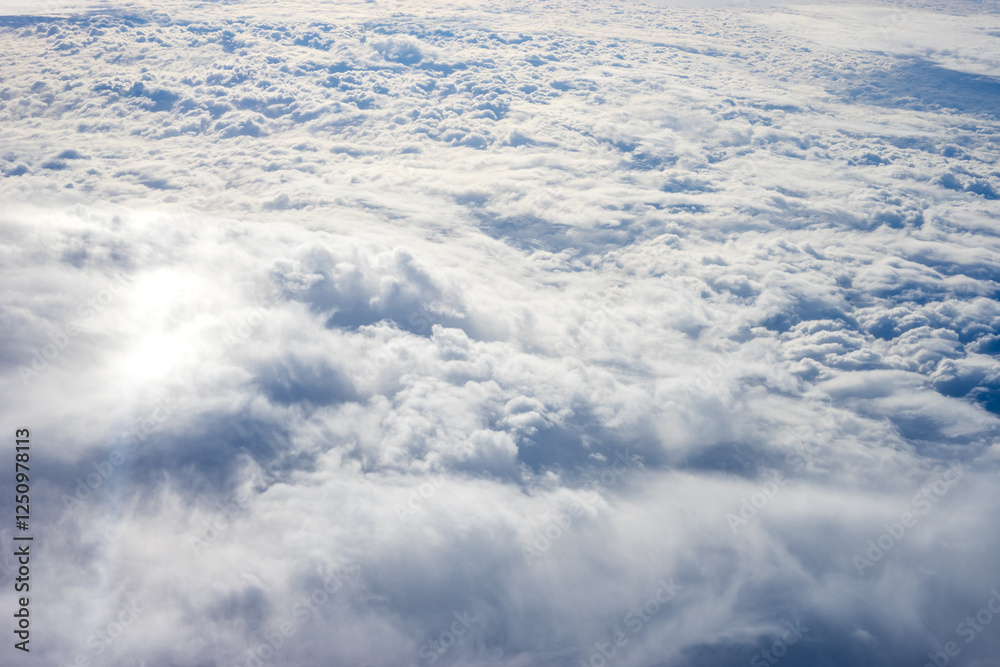 View of clouds from airplane window, clouds in a blue sky