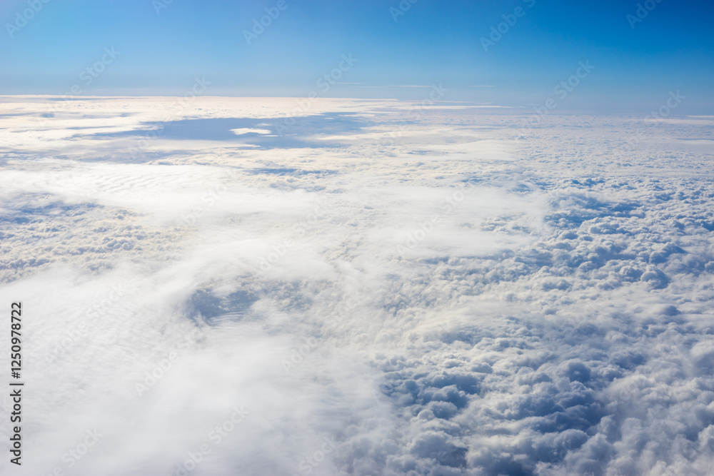 View of clouds from airplane window, clouds in a blue sky