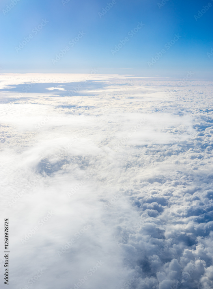 View of clouds from airplane window, clouds in a blue sky