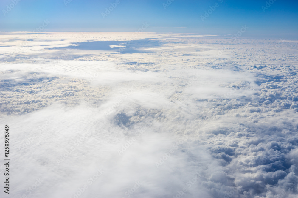 View of clouds from airplane window, clouds in a blue sky