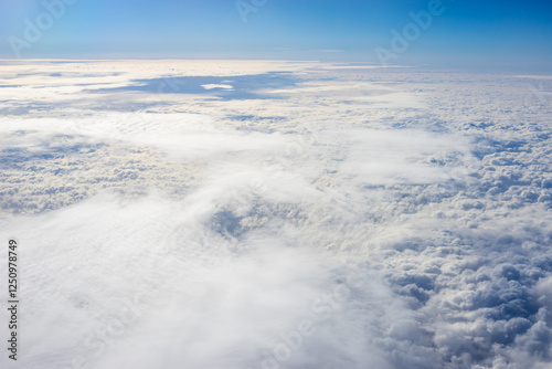 Obraz na płótnie View of clouds from airplane window, clouds in a blue sky w salonie