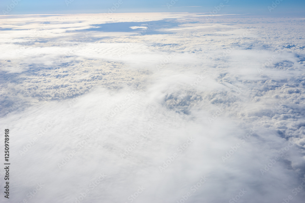 View of clouds from airplane window, clouds in a blue sky