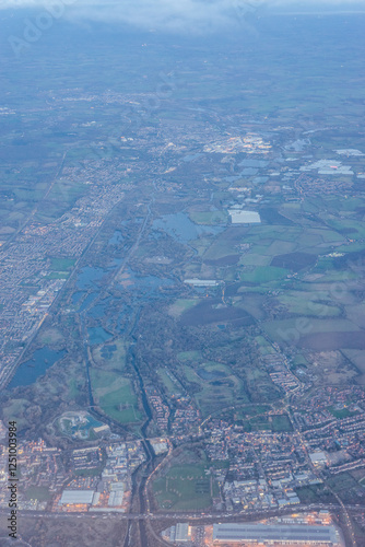 Obraz na płótnie Aerial view of London through early morning clouds at golden hour sunrise through the clouds w salonie