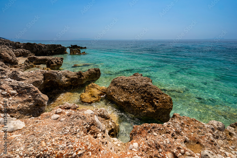 Albania, Vlorë County, Dhërmi - 14 August 2024 - The particular rocks and the clean sea in Dhërmi in Albania Albania, Vlorë County, Dhërmi - 14 August 2024 - The particular rocks and the clean sea in Dhërmi in Albania