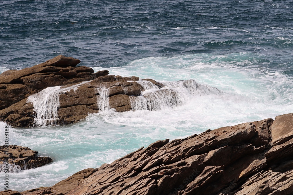 waves crashing on rocks in Brittany