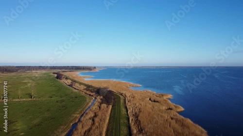 drone view of a coast of a lake with a hiking trail