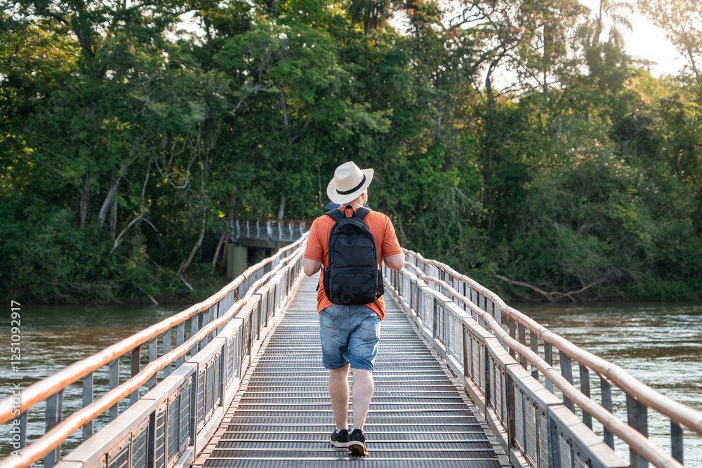 Hombre turista recorriendo las pasarelas del parque nacional Iguazú, en Argentina. Yendo de espaldas y con sombrero Hombre turista recorriendo las pasarelas del parque nacional Iguazú, en Argentina. Yendo de espaldas y con sombrero