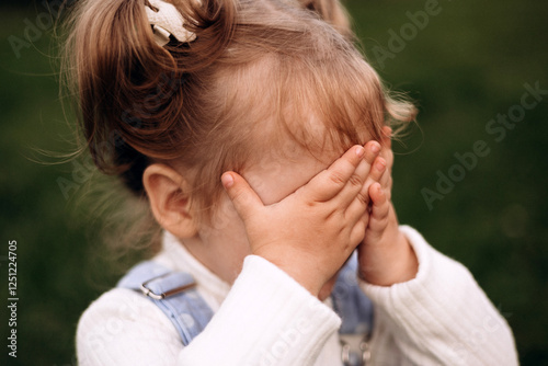 Little girl hiding her face