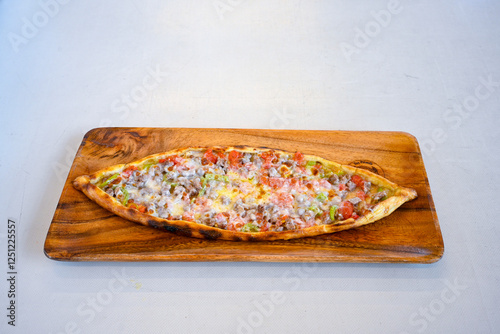 Kiymali pide.Turkish pide with minced meat. Turkish pizza mince pita Pide on white . Etli ekmek.Kusbasi kasarli, kiymali kasarli, kiymali yumurtali, Bafra, Trabzon, Kusbasili pide. Urfa acili lahmacun photo