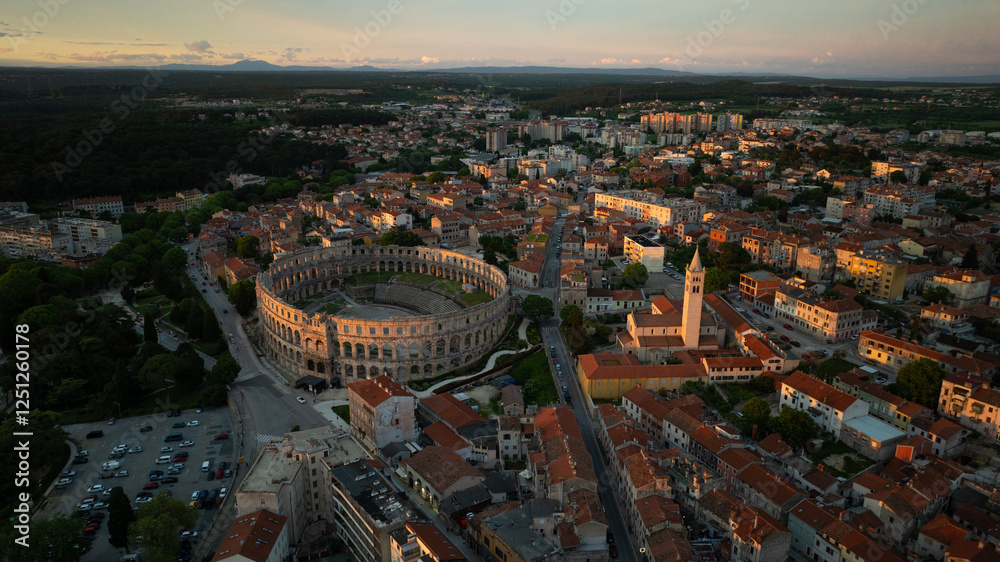 Obraz premium Flying above historic city of Pula , historic Roman amphitheatre of Pula aerial view, tourism in Croatia